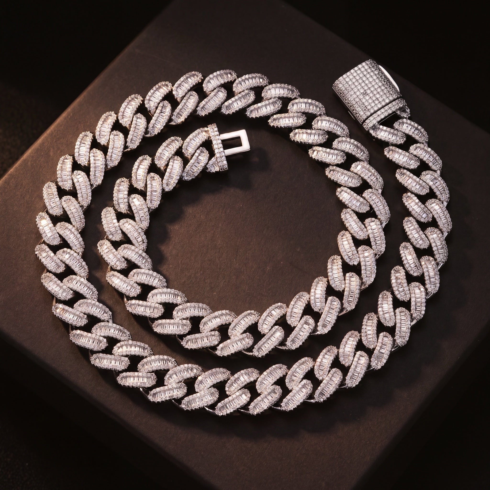 15 mm baguette iced Cuban link chain laid out on a dark surface